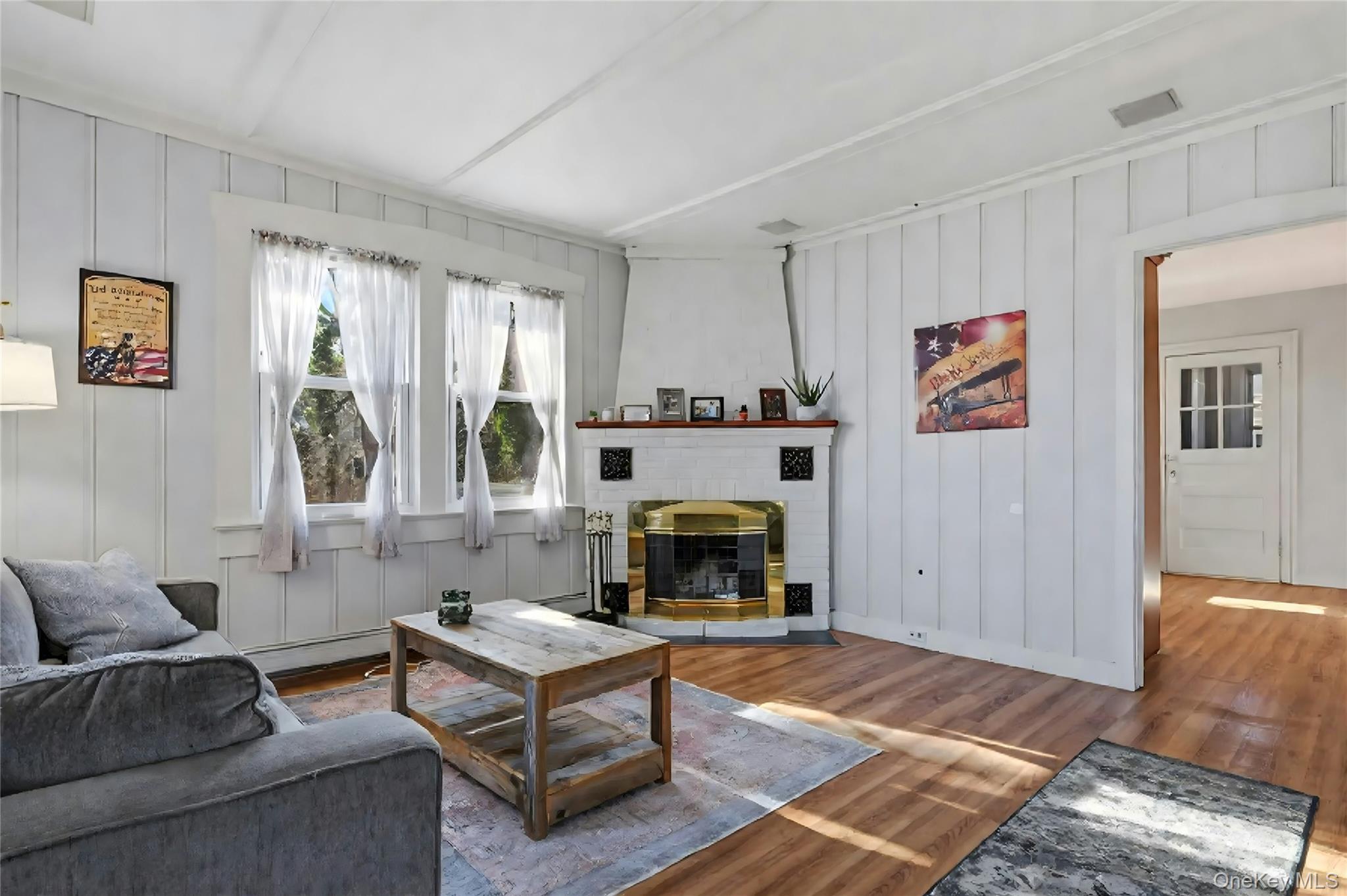 36 Columbine Road Rocky Point, NY 11778 - Photo 10 of 37 a living room with furniture and a fireplace