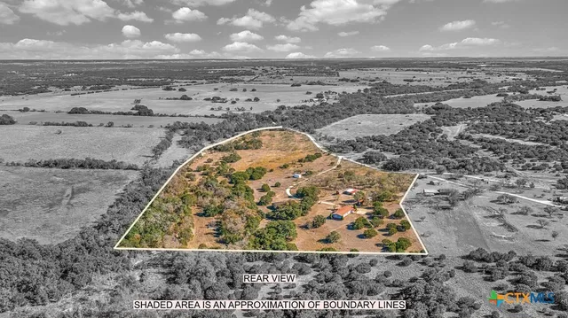 a view of a backyard with wooden fence