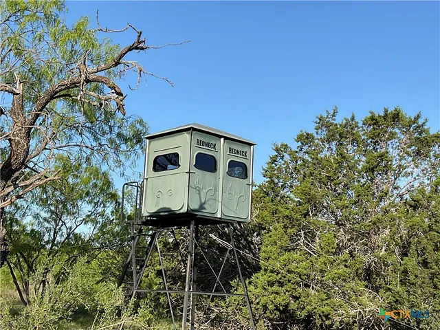 a view of a house with a yard and a garage