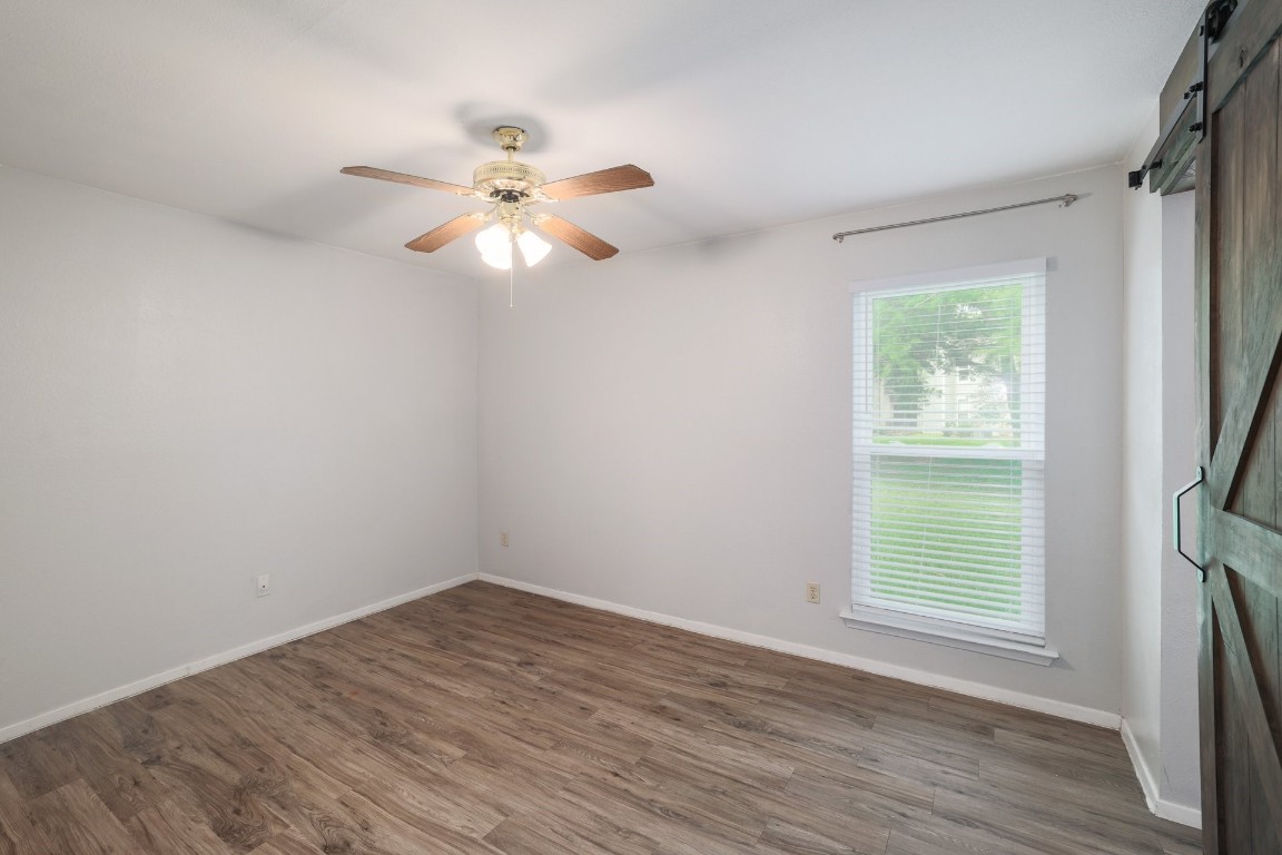 10616 Mellow Meadow Drive, Unit 46A Austin, TX 78750 - Photo 9 of 23 Custom barn door, and ceiling fan, for the primary bedroom.