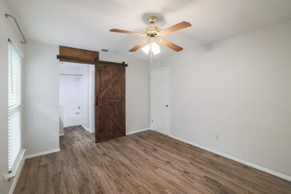 a kitchen with a sink a refrigerator and wooden floor