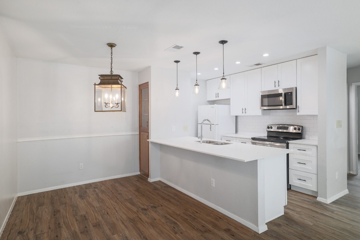 10616 Mellow Meadow Drive, Unit 46A Austin, TX 78750 - Photo 6 of 23 Nicely updated kitchen in all white! Pendant lights above the island, and stainless steel appliances. Fridge is included.