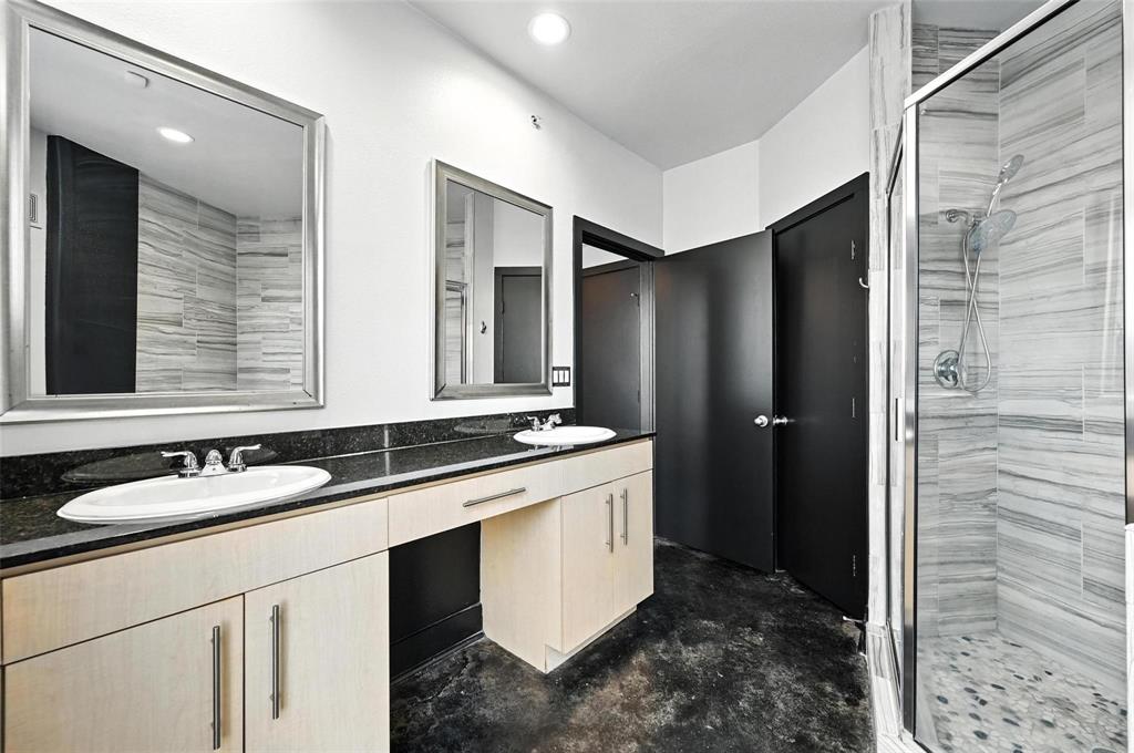 4414 Cedar Springs Road, Unit 124 Dallas, TX 75219 - Photo 11 of 20 a bathroom with a granite countertop sink and a mirror