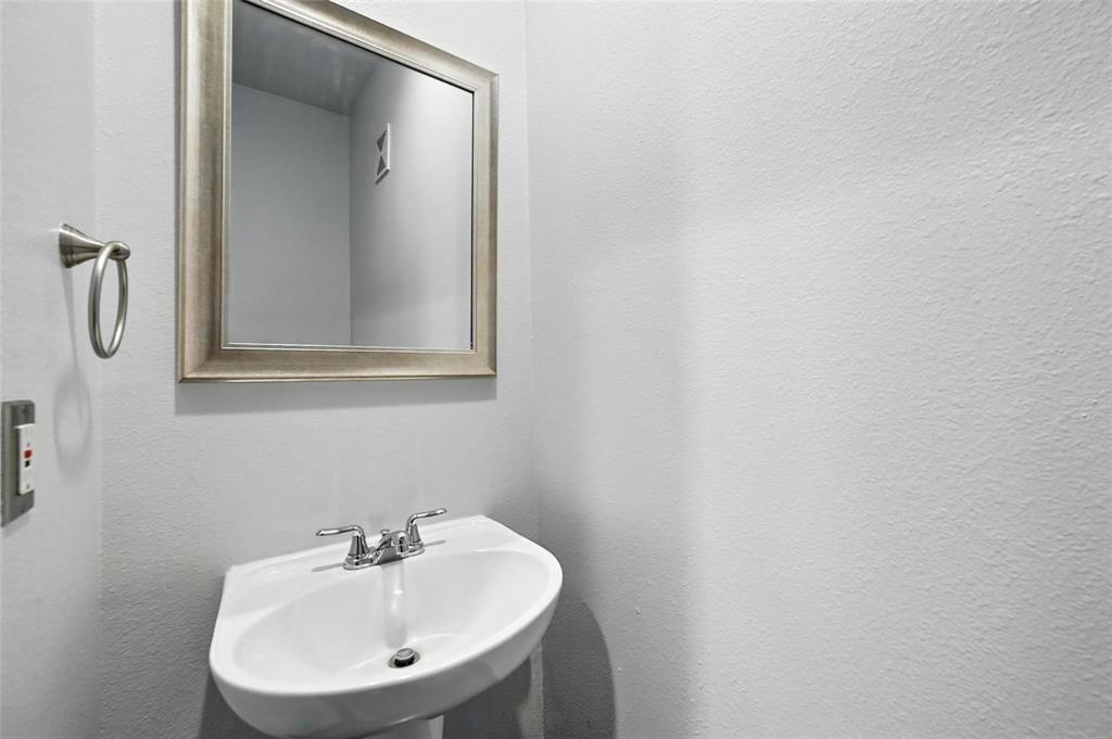 4414 Cedar Springs Road, Unit 124 Dallas, TX 75219 - Photo 14 of 20 a bathroom with a sink and a mirror