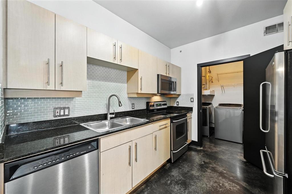 4414 Cedar Springs Road, Unit 124 Dallas, TX 75219 - Photo 2 of 20 a kitchen with stainless steel appliances granite countertop a sink stove and refrigerator