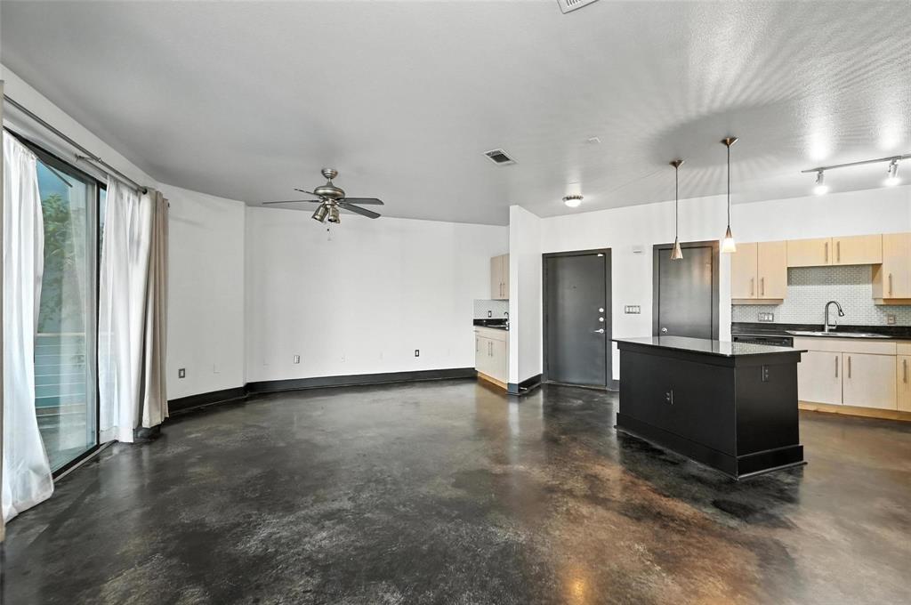 4414 Cedar Springs Road, Unit 124 Dallas, TX 75219 - Photo 3 of 20 a view of a kitchen with a sink and refrigerator
