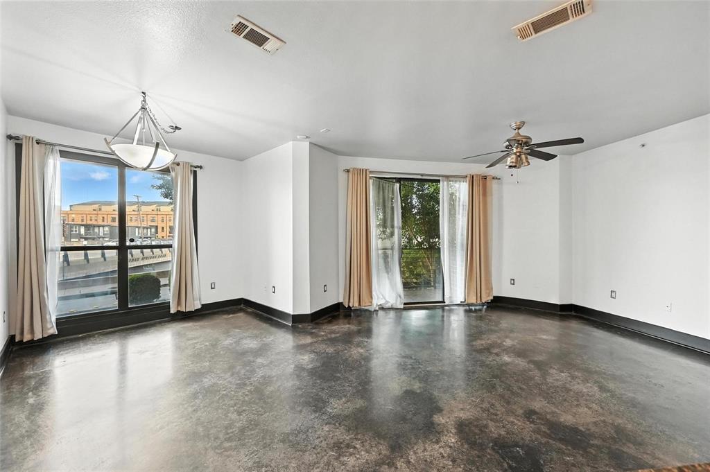 4414 Cedar Springs Road, Unit 124 Dallas, TX 75219 - Photo 7 of 20 wooden floor in an empty room with a window