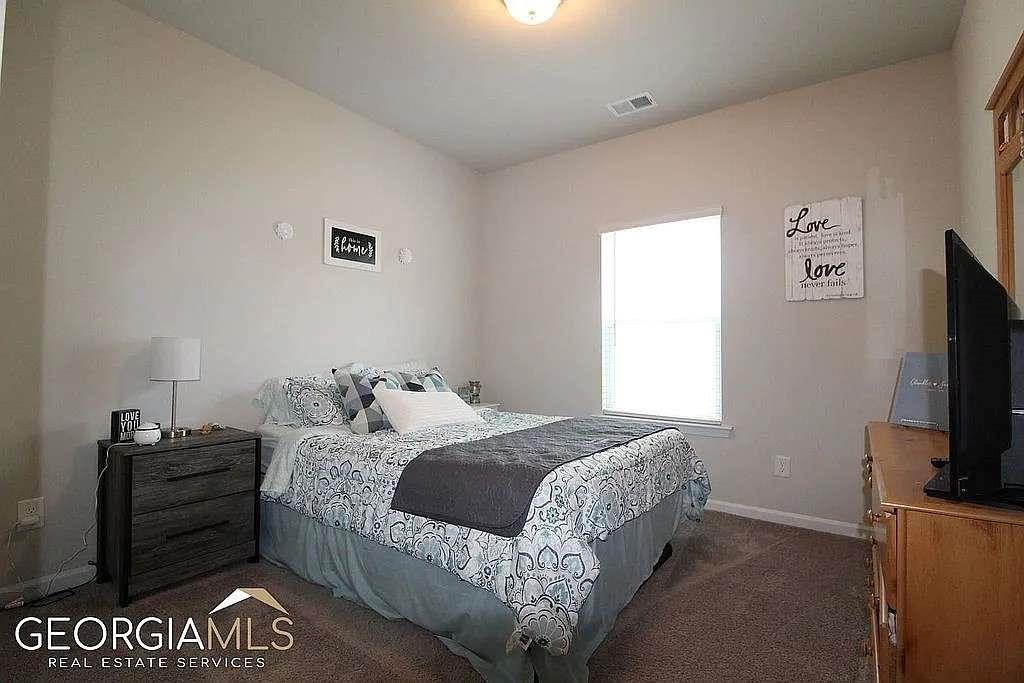 6 Gala Drive Northeast Rome, GA 30165 - Photo 8 of 11 a bedroom with a bed and a television