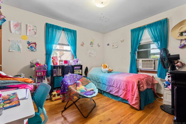 a bed room with furniture and a flat screen tv