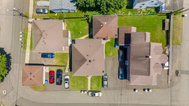 an aerial view of a house with outdoor space pool seating area and fire pit