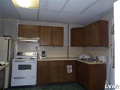 636 Ridge Avenue Allentown, PA 18102 - Photo 3 of 4 a kitchen with a sink a stove and cabinets