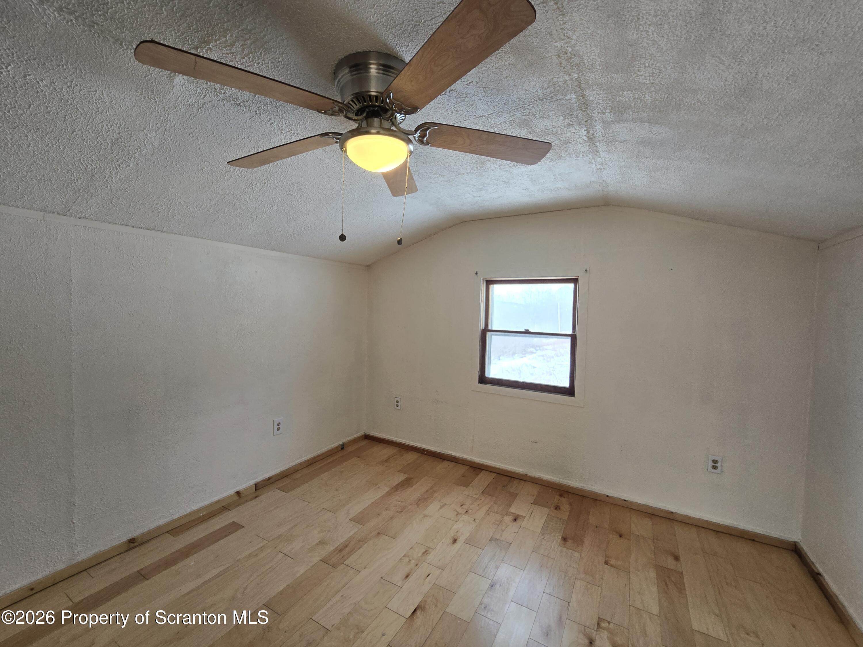 483 Turnpike Street Susquehanna, PA 18847 - Photo 24 of 27 an empty room with a window and ceiling fan
