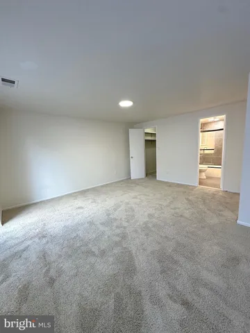 a bathroom with a sink and mirror with toilet