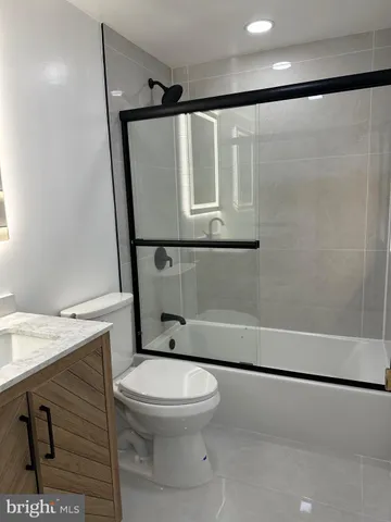 a bathroom with a double vanity sink toilet and shower