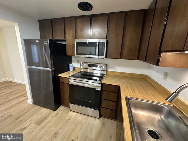 a kitchen with a appliances and a cabinets