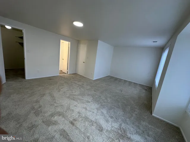 a view of an empty room and a window