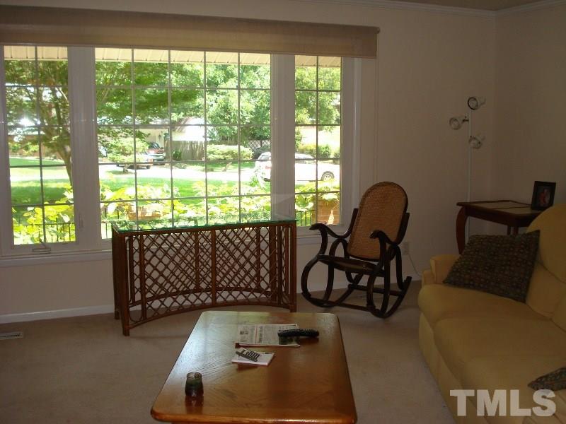 505 Roxanne Drive Raleigh, NC 27603 - Photo 14 of 25 a living room with furniture and a floor to ceiling window