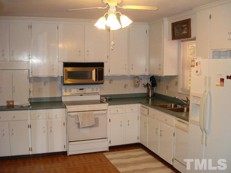 505 Roxanne Drive Raleigh, NC 27603 - Photo 15 of 25 a kitchen with white cabinets and sink