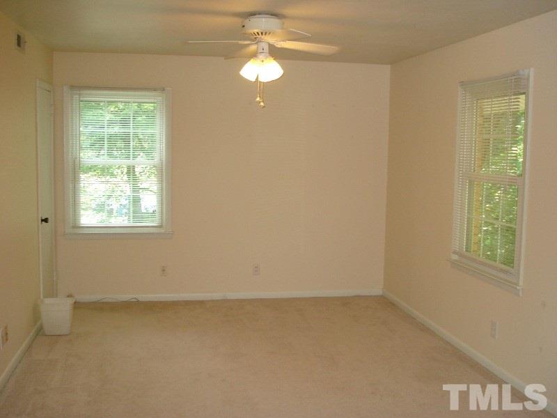 505 Roxanne Drive Raleigh, NC 27603 - Photo 17 of 25 an empty room with windows and fan