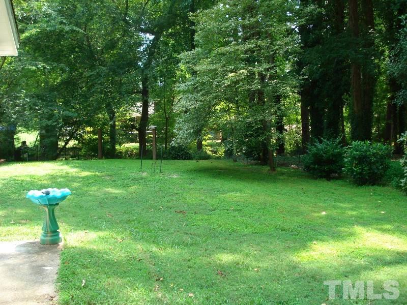 505 Roxanne Drive Raleigh, NC 27603 - Photo 8 of 25 a view of a garden with a fountain