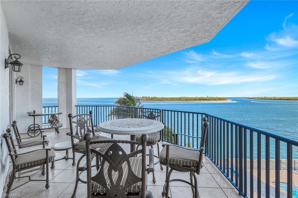700 La Peninsula Boulevard, Unit 305 Naples, FL 34113 - Photo 17 of 39 a view of a chairs and table in patio