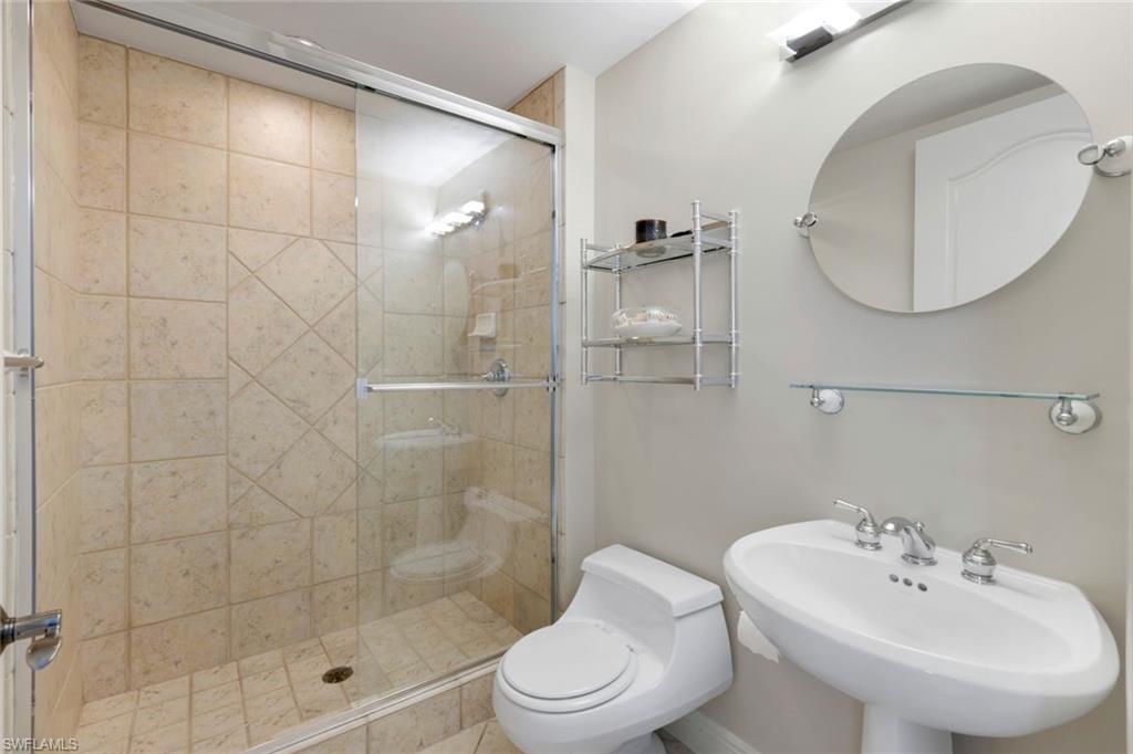 700 La Peninsula Boulevard, Unit 305 Naples, FL 34113 - Photo 27 of 39 a bathroom with a sink a toilet and shower