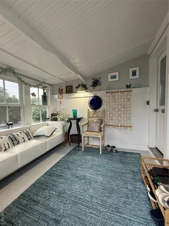 a bedroom with furniture and a large window
