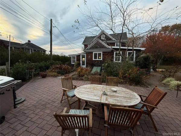 a view of a patio with table and chairs and potted plants