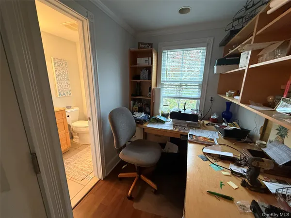 a view of a workspace with furniture and a window
