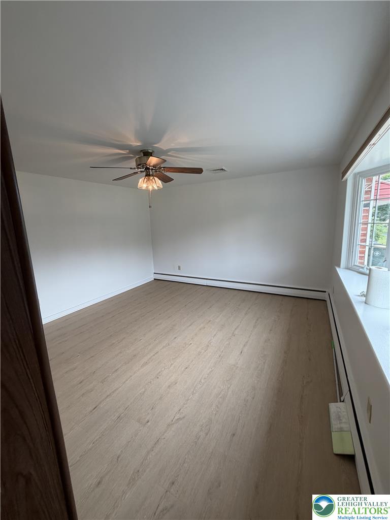 5391 Chapmans Road, Unit 2 Orefield, PA 18069 - Photo 13 of 22 A well-lit room featuring durable wood flooring and ample natural illumination from the window.