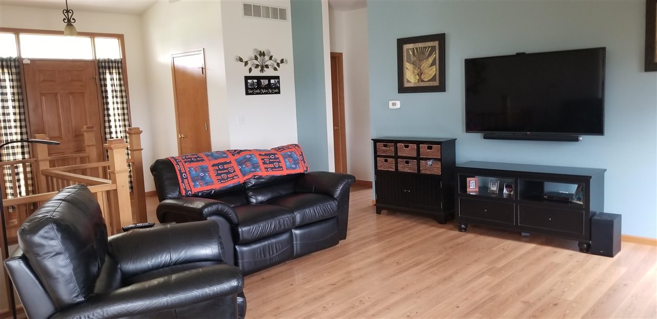 7611 North Crestview Road Stillman Valley, IL 61084 - Photo 6 of 20 a living room with furniture and a flat screen tv