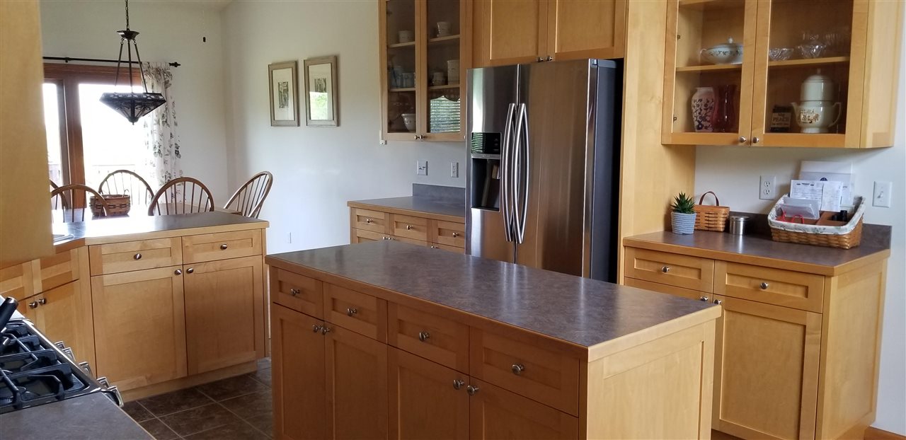 7611 North Crestview Road Stillman Valley, IL 61084 - Photo 8 of 20 a kitchen with stainless steel appliances granite countertop a refrigerator a sink a stove and island