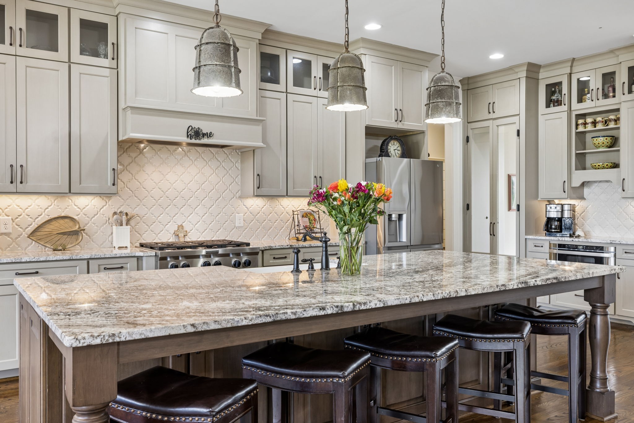 6033 Native Pony Trail College Grove, TN 37046 - Photo 28 of 87 a kitchen with granite countertop kitchen island stainless steel appliances a sink stove and cabinets