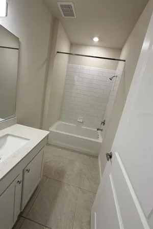 a bathroom with a sink and shower