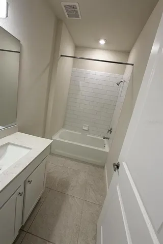 a bathroom with a sink and shower
