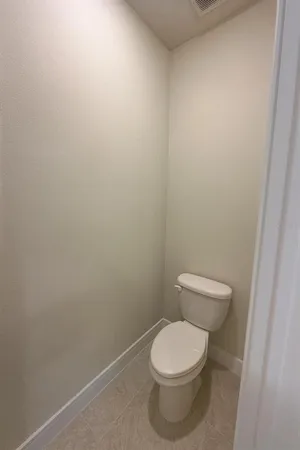 a white toilet sitting next to a white sink