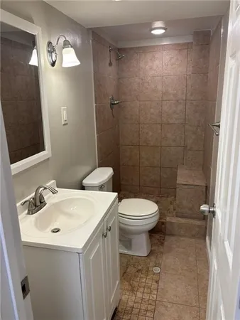 a bathroom with a sink a toilet and a mirror