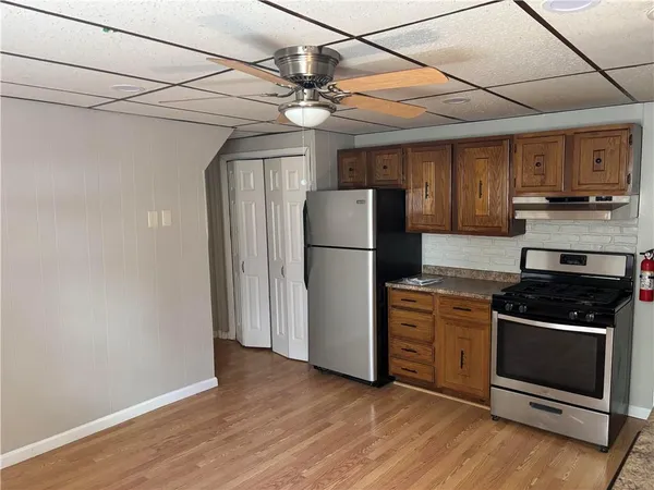 a kitchen with a refrigerator and a stove top oven
