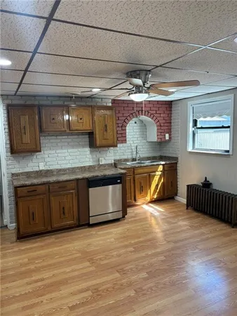 a kitchen with stainless steel appliances granite countertop a sink a stove and a wooden floors