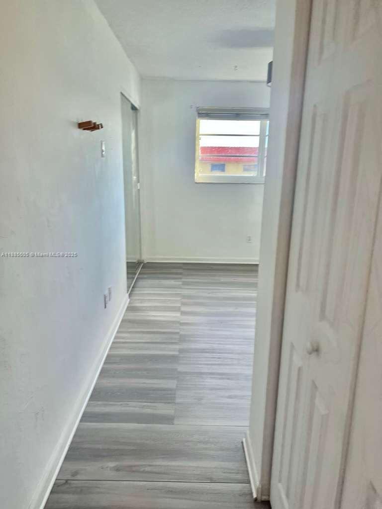 1300 West 53rd Street, Unit 18 Hialeah, FL 33012 - Photo 11 of 16 a view of hallway with wooden floor