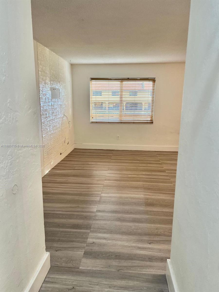 1300 West 53rd Street, Unit 18 Hialeah, FL 33012 - Photo 14 of 16 a view of an empty room with a window
