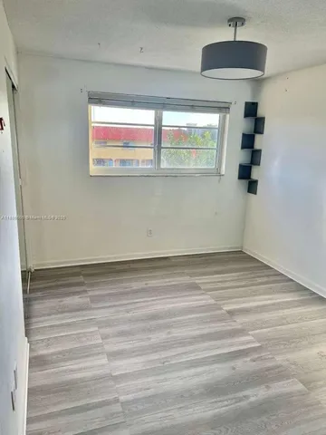 a view of hallway with wooden floor