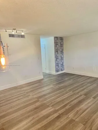 wooden floor in a hall with a window