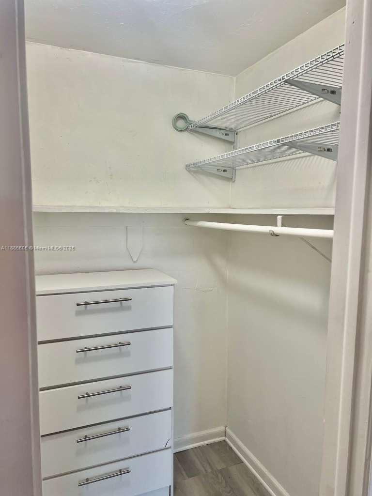 1300 West 53rd Street, Unit 18 Hialeah, FL 33012 - Photo 10 of 16 a view of walk in closet with empty racks