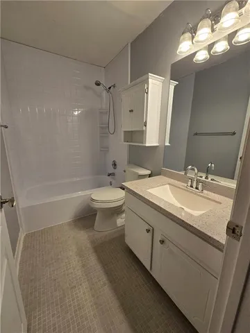 a bathroom with a double vanity sink toilet mirror and window