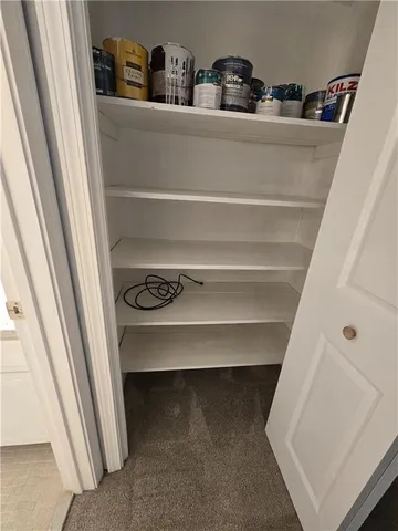 an empty room with windows and ceiling fan