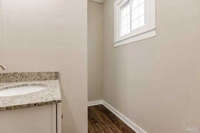 a bathroom with a granite countertop sink and vanity