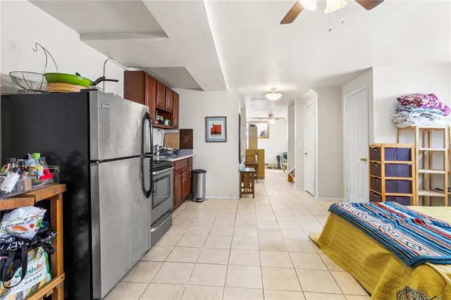 a kitchen with stainless steel appliances granite countertop a refrigerator and a sink