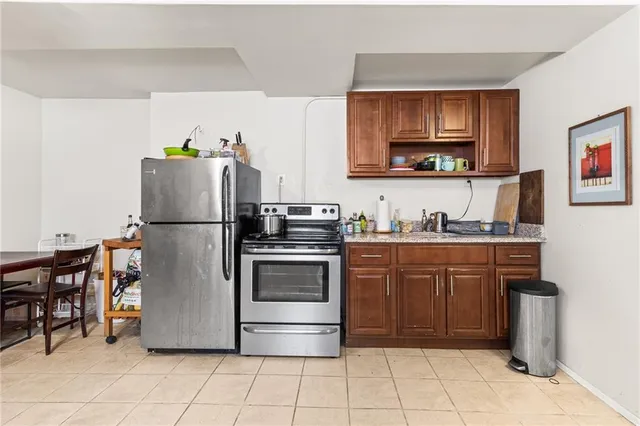 a kitchen with stainless steel appliances granite countertop a refrigerator and a stove top oven