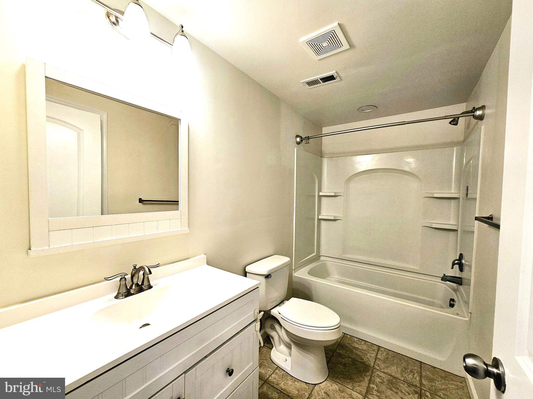 143 Mitscher Road Dover, DE 19901 - Photo 17 of 25 a bathroom with a sink mirror vanity and toilet